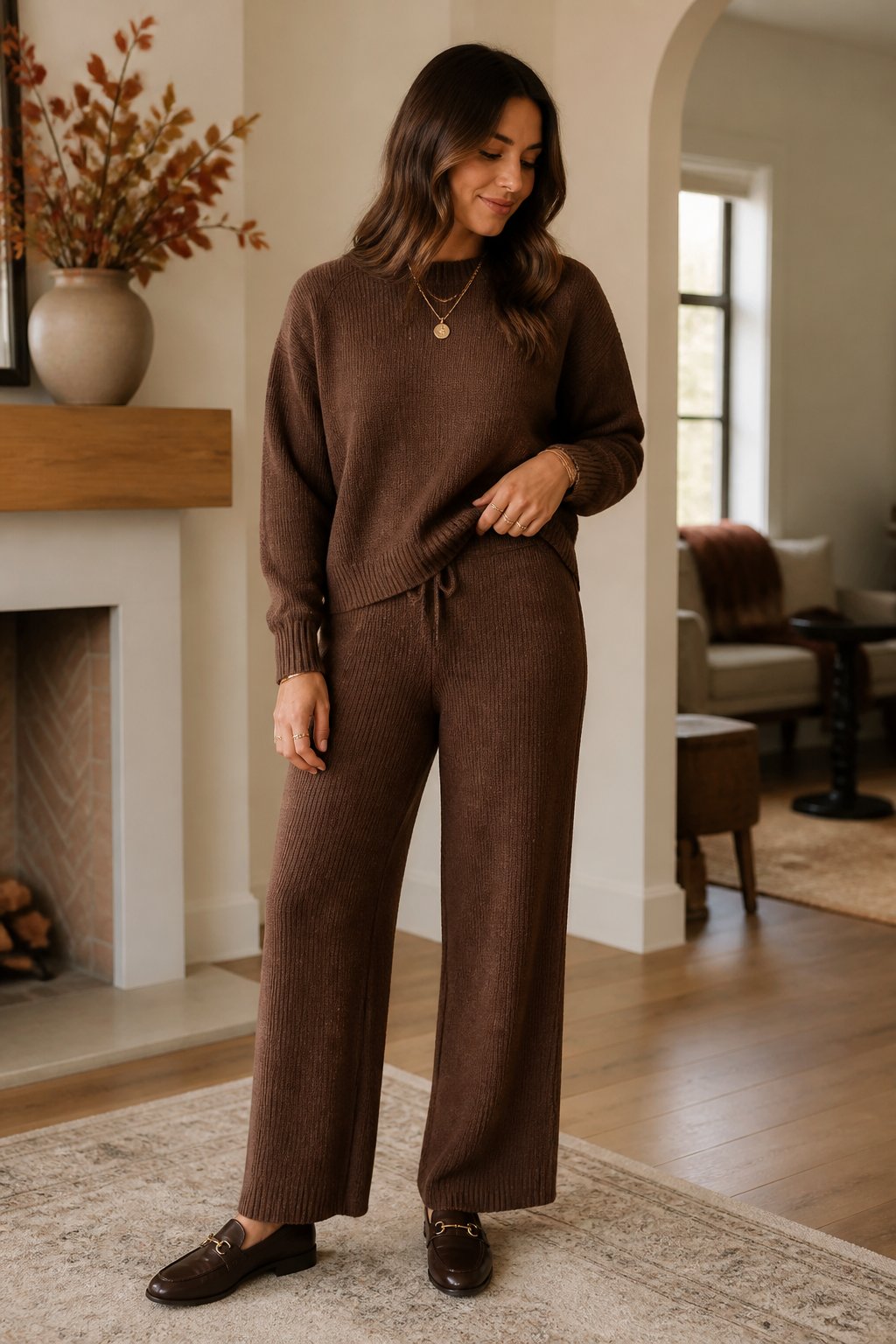Woman wearing a warm knit set, gold jewelry, and loafers for a deep autumn outfit
